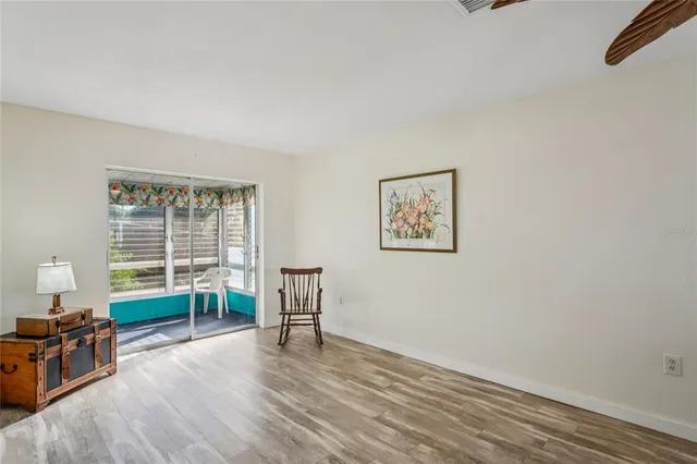 a view of a livingroom with furniture wooden floor and a window