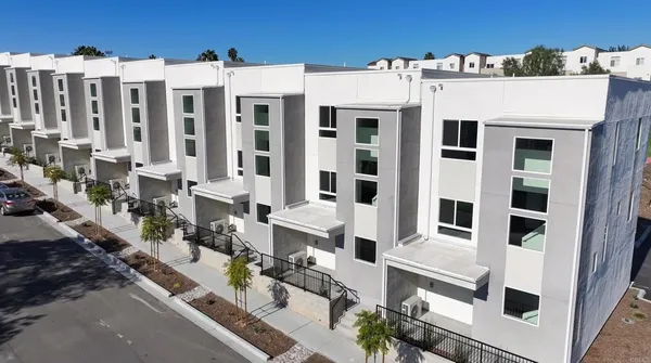 a view of a white building with many windows
