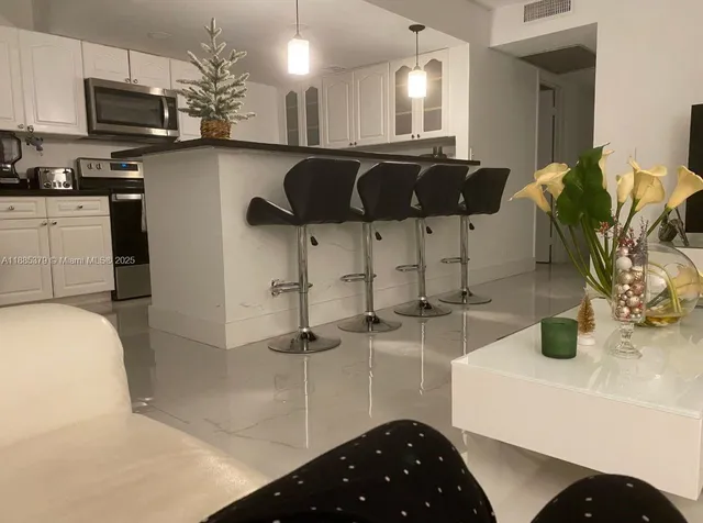 a kitchen with stainless steel appliances granite countertop a sink a stove and cabinets