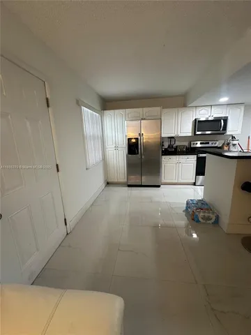 a kitchen with stainless steel appliances a refrigerator and a sink