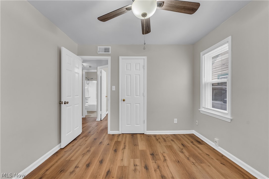 18517 Homeway Road Cleveland, OH 44135 - Photo 16 of 29 Spacious room featuring wood-finish flooring, light gray wall paint, and white trim
