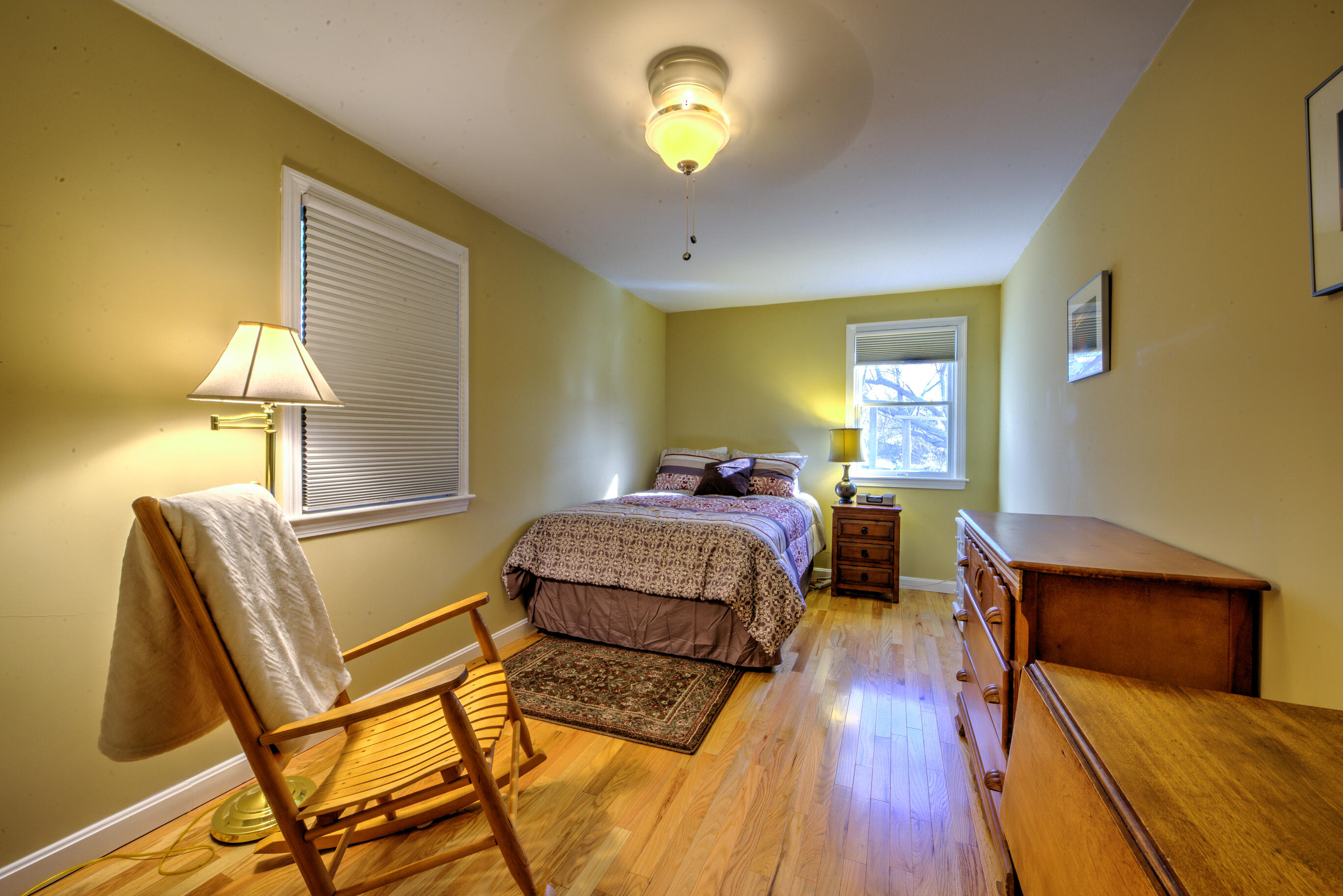 131 North Shore Boulevard, Unit 2A East Sandwich, MA 02537 - Photo 9 of 13 a bedroom with a bed and a lamp with wooden floor