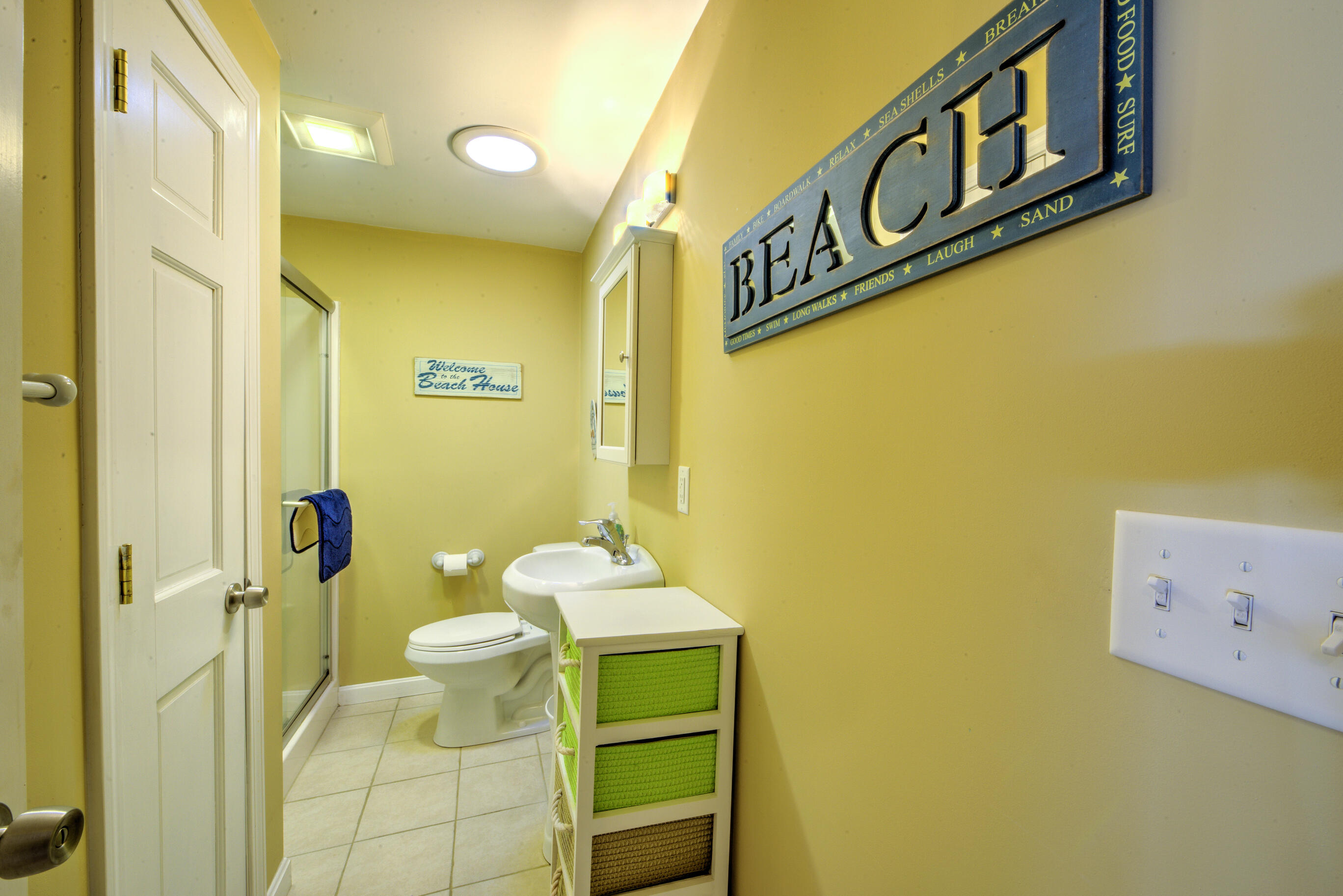 131 North Shore Boulevard, Unit 2A East Sandwich, MA 02537 - Photo 10 of 13 a bathroom with a sink mirror and toilet