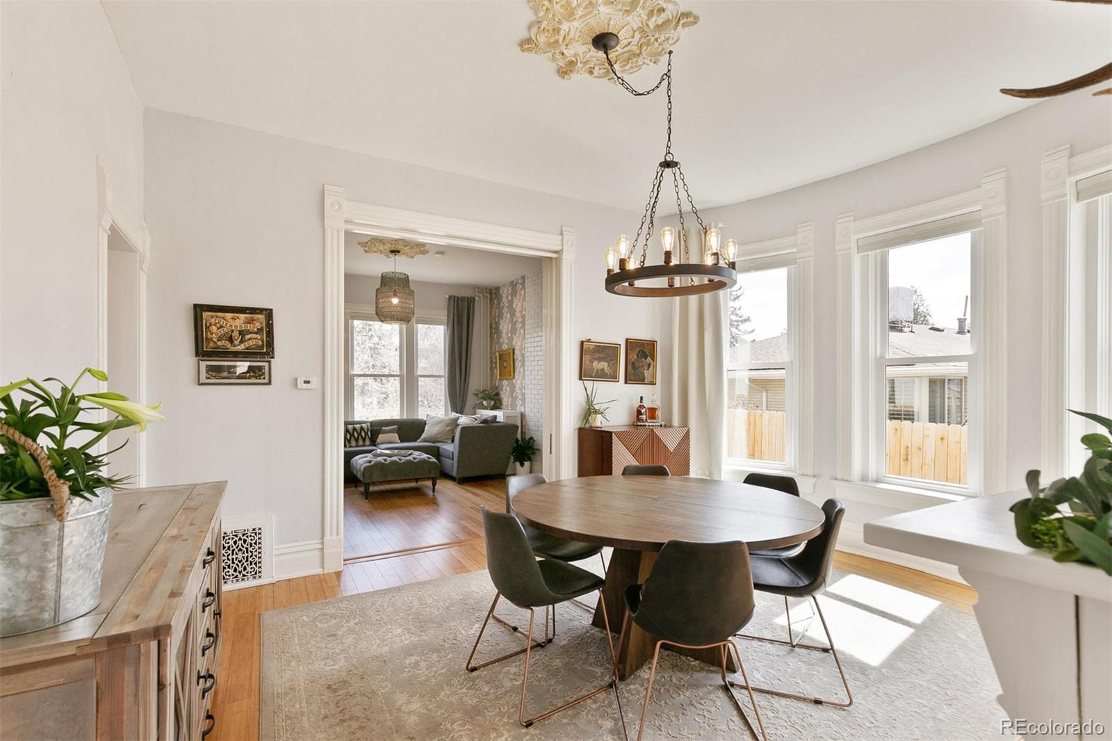 5127 Lowell Boulevard Denver, CO 80221 - Photo 12 of 39 a view of a dining room with furniture window and wooden floor