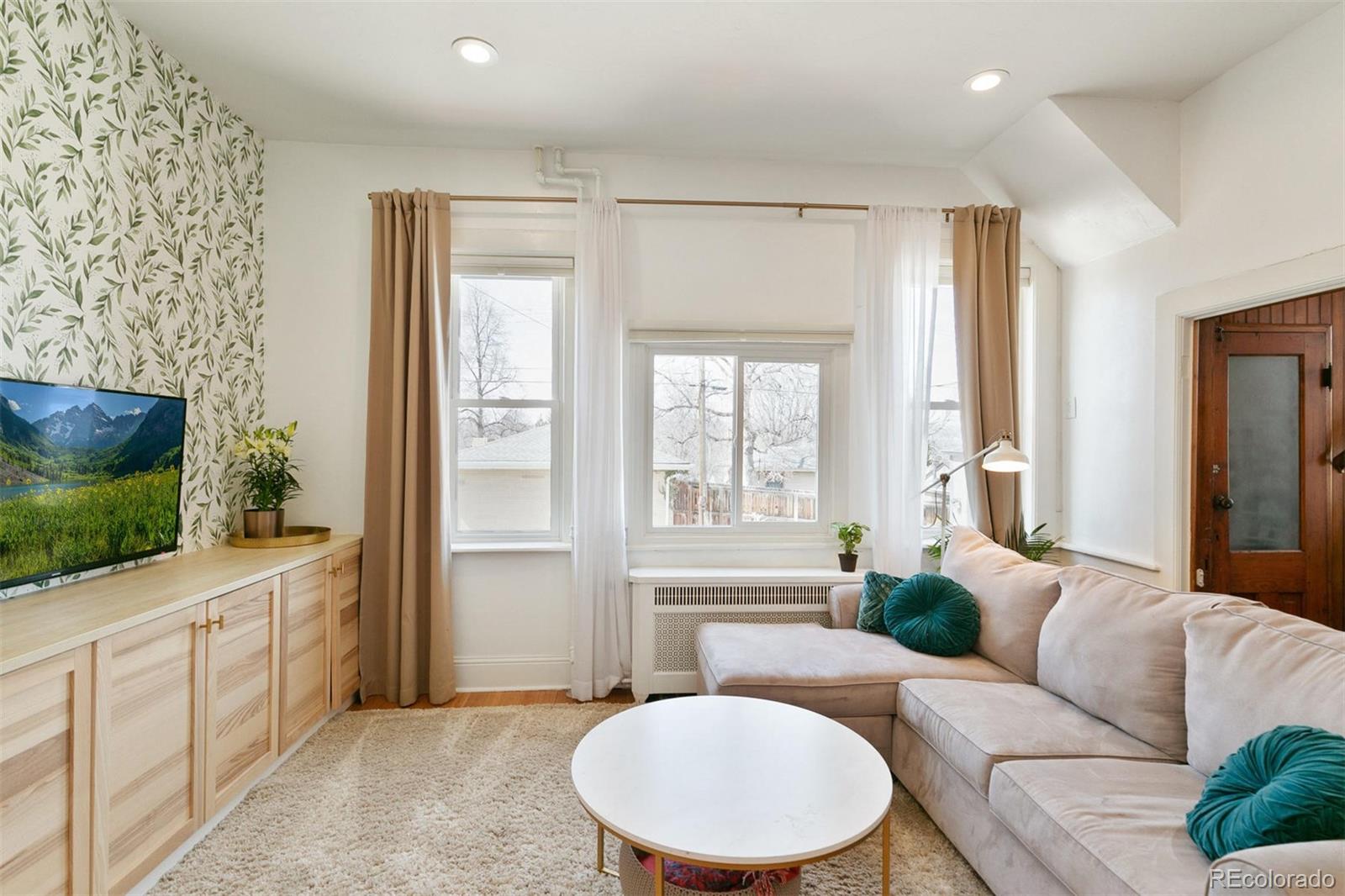 5127 Lowell Boulevard Denver, CO 80221 - Photo 14 of 39 a living room with furniture and a flat screen tv