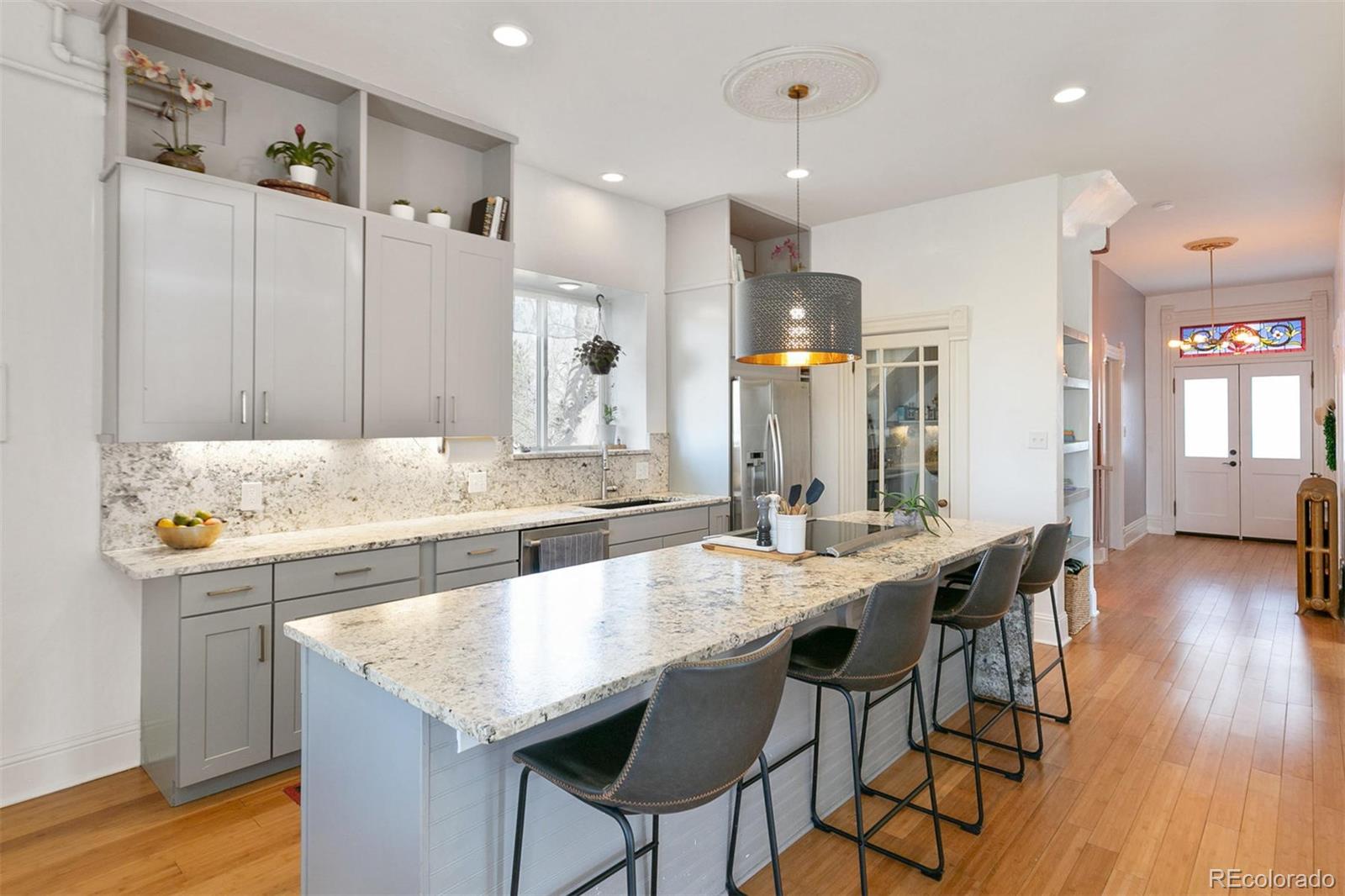 5127 Lowell Boulevard Denver, CO 80221 - Photo 17 of 39 a kitchen with granite countertop kitchen island a sink and a refrigerator