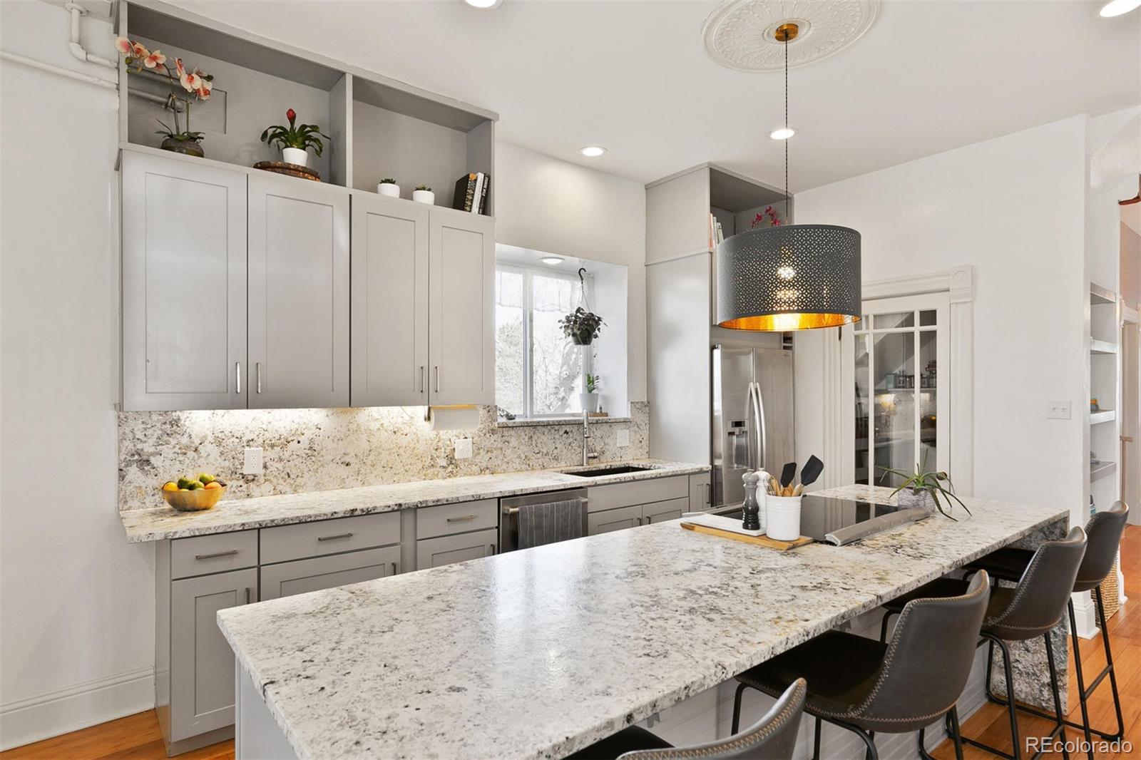 5127 Lowell Boulevard Denver, CO 80221 - Photo 18 of 39 a kitchen with granite countertop a sink and a refrigerator