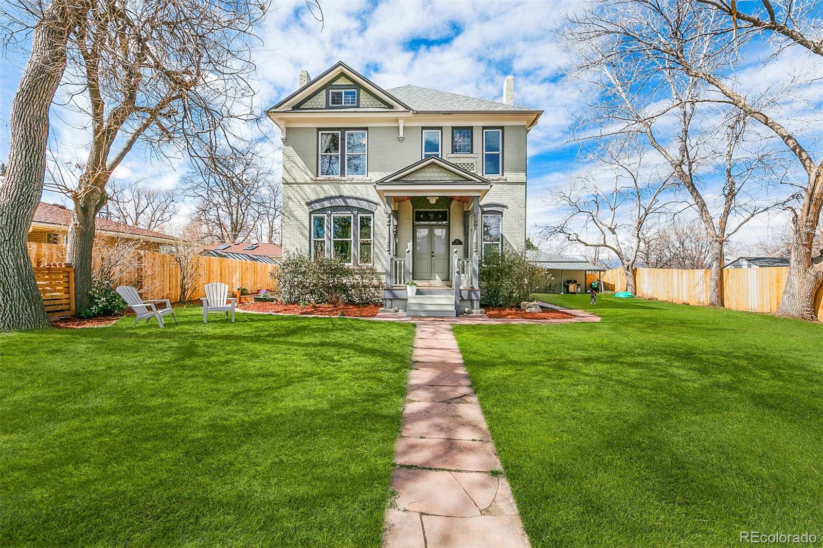 5127 Lowell Boulevard Denver, CO 80221 - Photo 2 of 39 a front view of a house with a yard