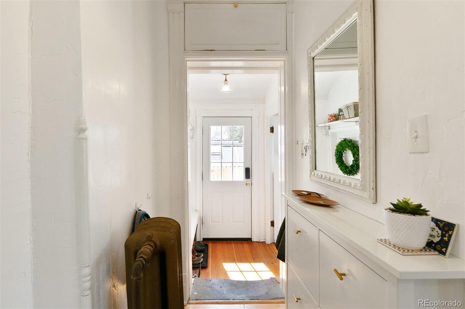 5127 Lowell Boulevard Denver, CO 80221 - Photo 21 of 39 a living room with furniture and mirror