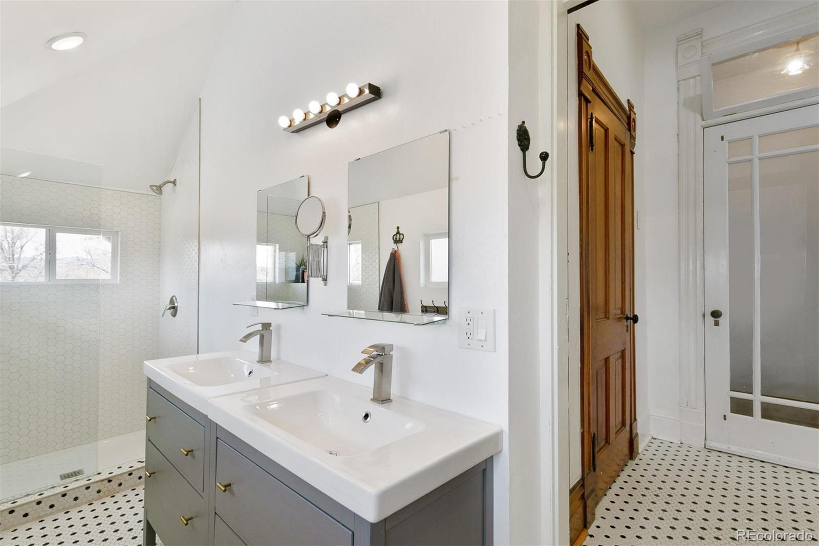 5127 Lowell Boulevard Denver, CO 80221 - Photo 27 of 39 a bathroom with a sink and a mirror
