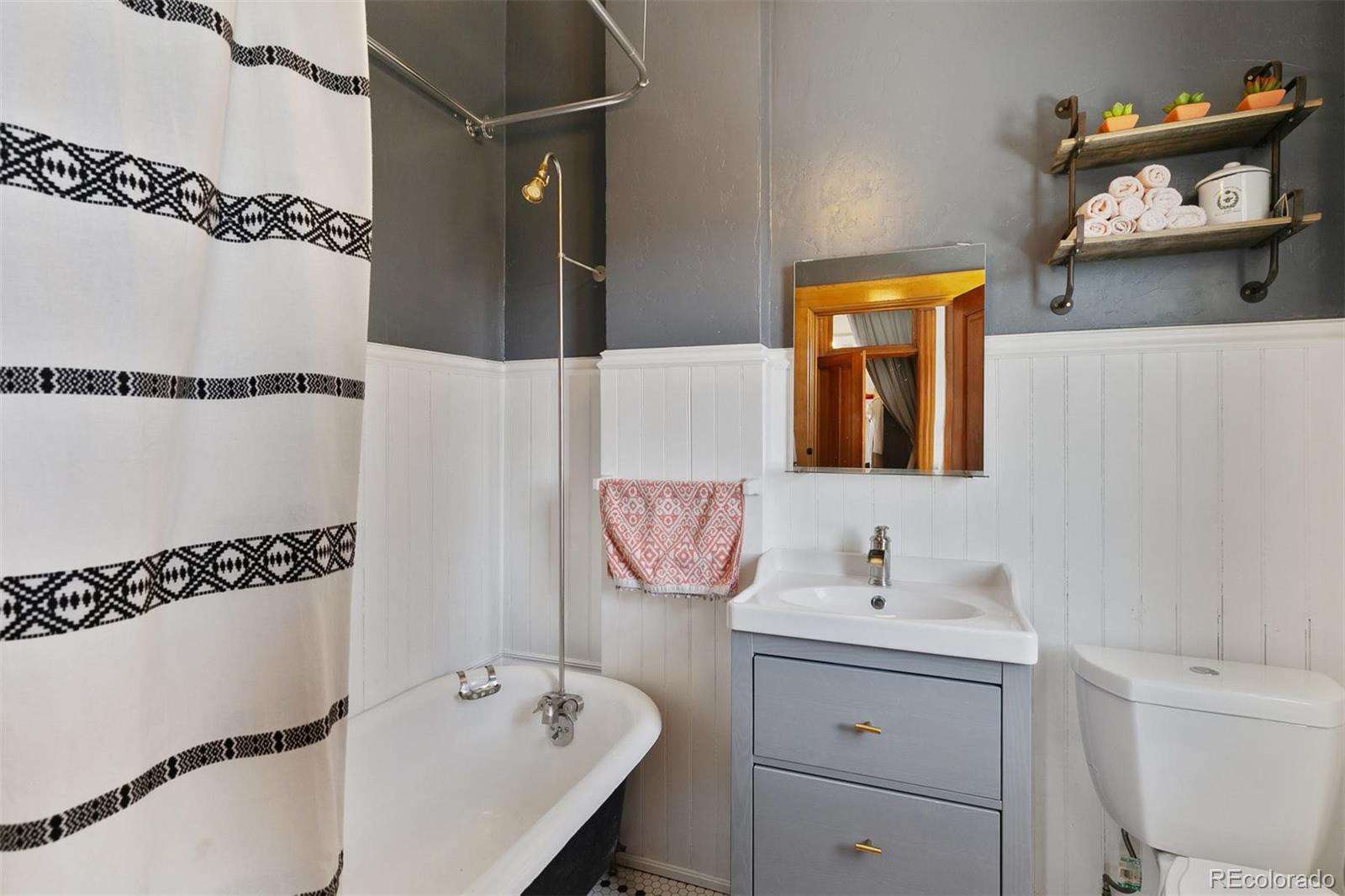 5127 Lowell Boulevard Denver, CO 80221 - Photo 30 of 39 a bathroom with a bathtub sink and mirror