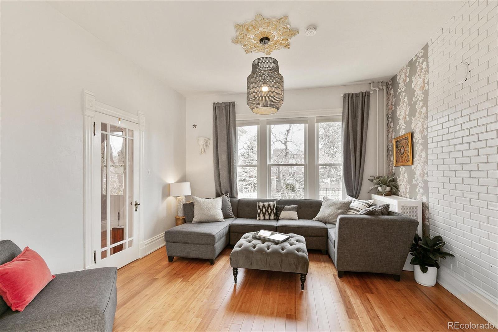 5127 Lowell Boulevard Denver, CO 80221 - Photo 9 of 39 a bedroom with a bed couch and window