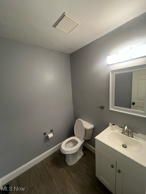 10422 Reno Avenue Cleveland, OH 44105 - Photo 8 of 21 Bathroom featuring vanity, toilet, and wood-type flooring