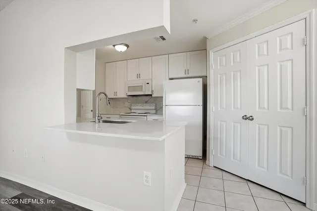 a bedroom with a large bed couch and a window