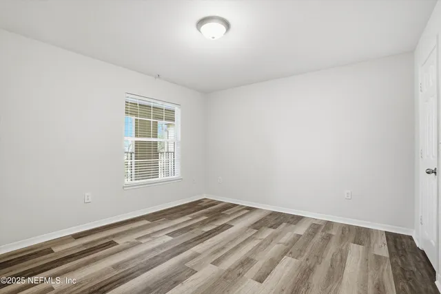a front view of a house with a yard and potted plants