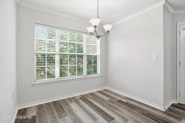 a large white kitchen with stainless steel appliances granite countertop a sink and dishwasher a stove top oven with white cabinets