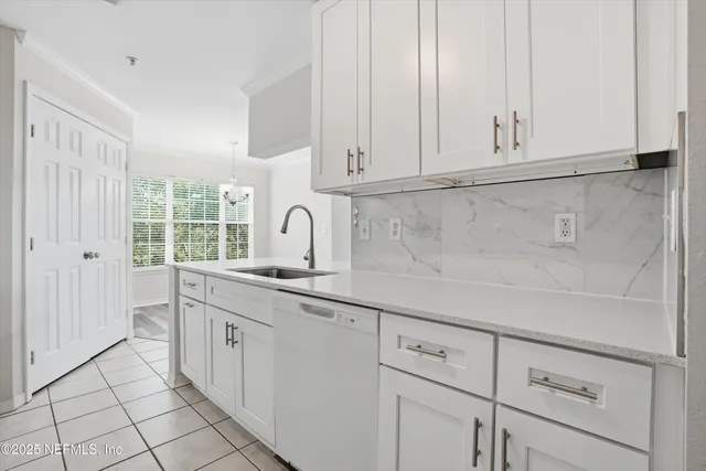 a kitchen with white cabinets and white appliances