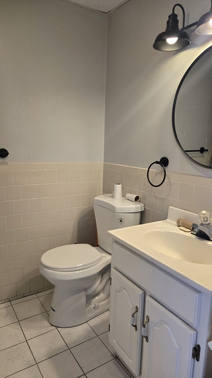 651 Washington Street Canton, MA 02021 - Photo 11 of 13 a bathroom with a sink mirror vanity and toilet