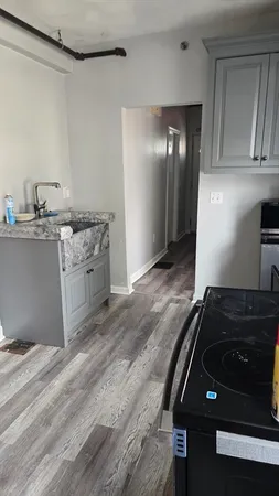 a kitchen with granite countertop a stove and a sink