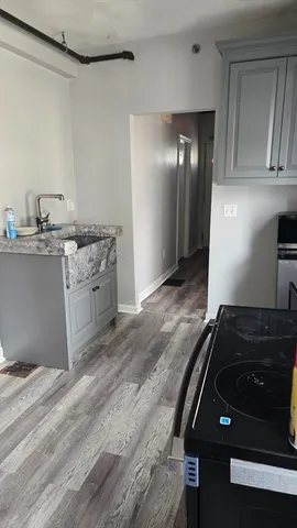 a kitchen with granite countertop a stove and a sink