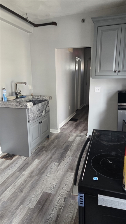 651 Washington Street Canton, MA 02021 - Photo 7 of 13 a kitchen with granite countertop a stove and a sink