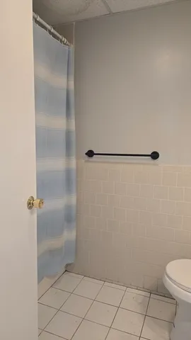 a bathroom with a glass shower door