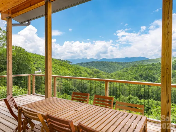 a view of a balcony with lake view and wooden floor