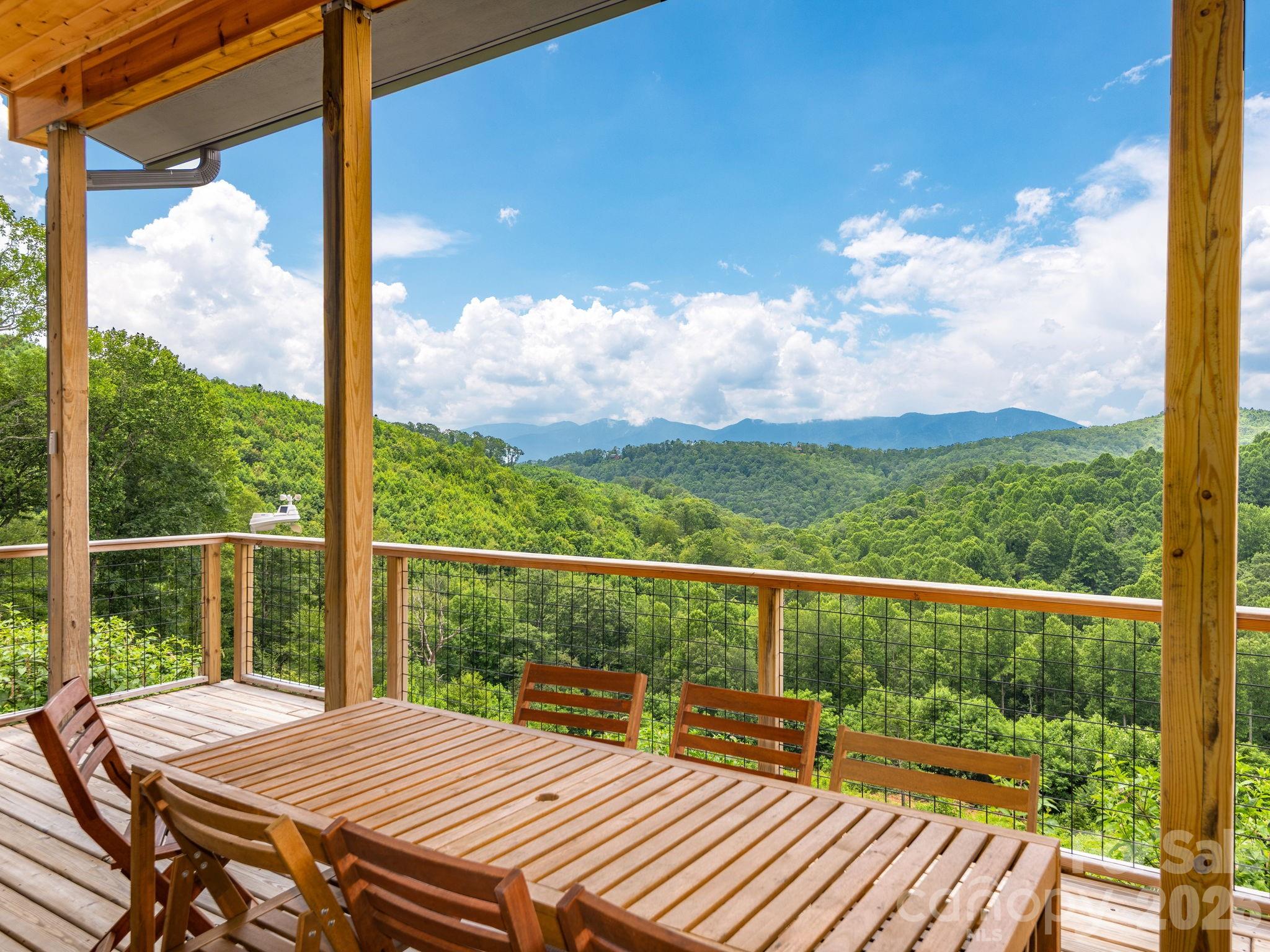 a view of a balcony with lake view and wooden floor