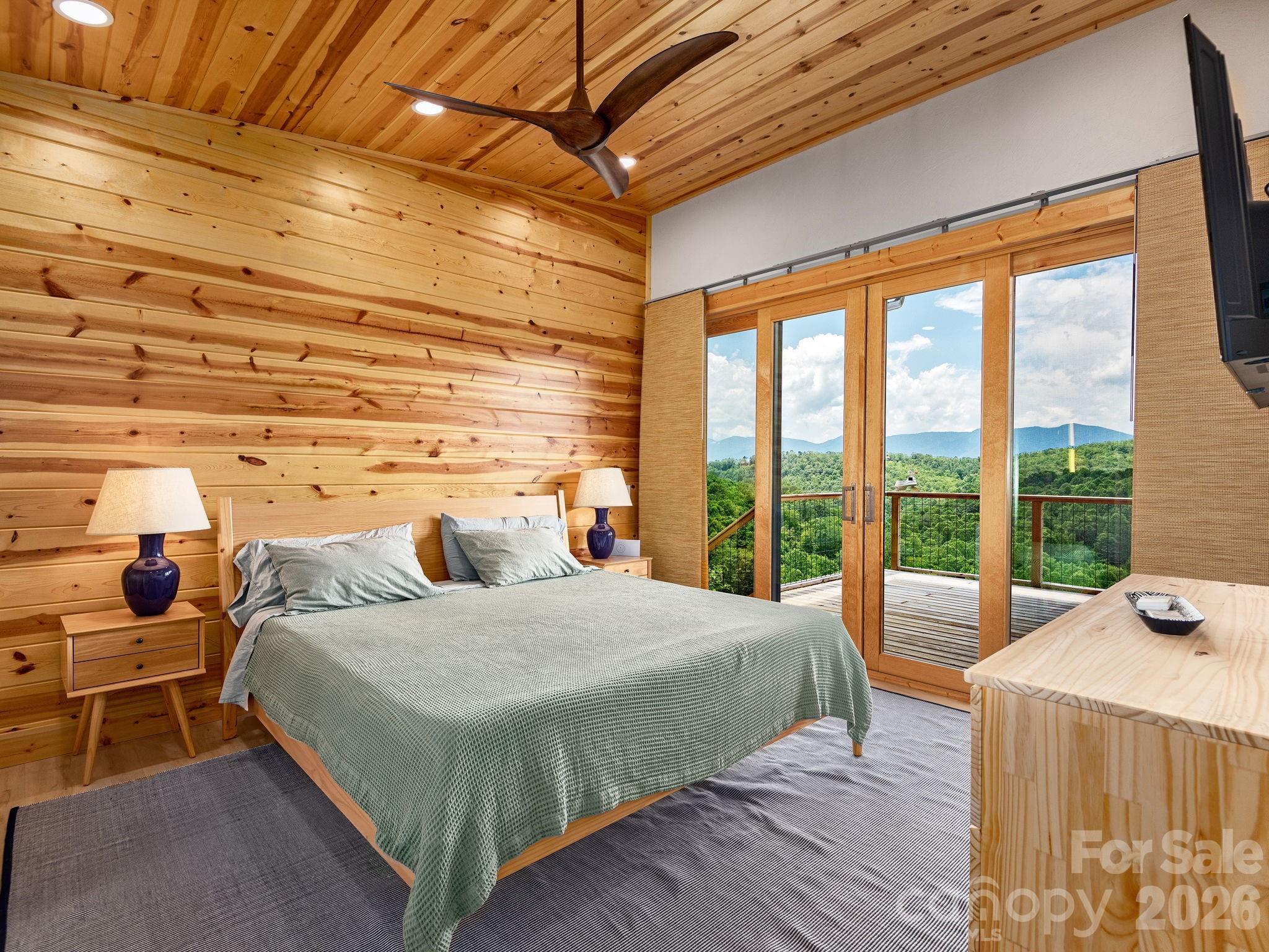 511 Emerald Mine Road Spruce Pine, NC 28777 - Photo 11 of 23 a bedroom with a bed and wooden floor