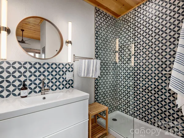 a bathroom with a sink a toilet and a mirror