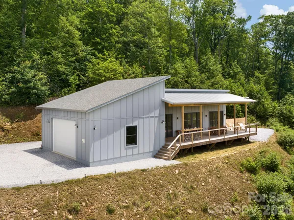 a backyard of a house with table and chairs