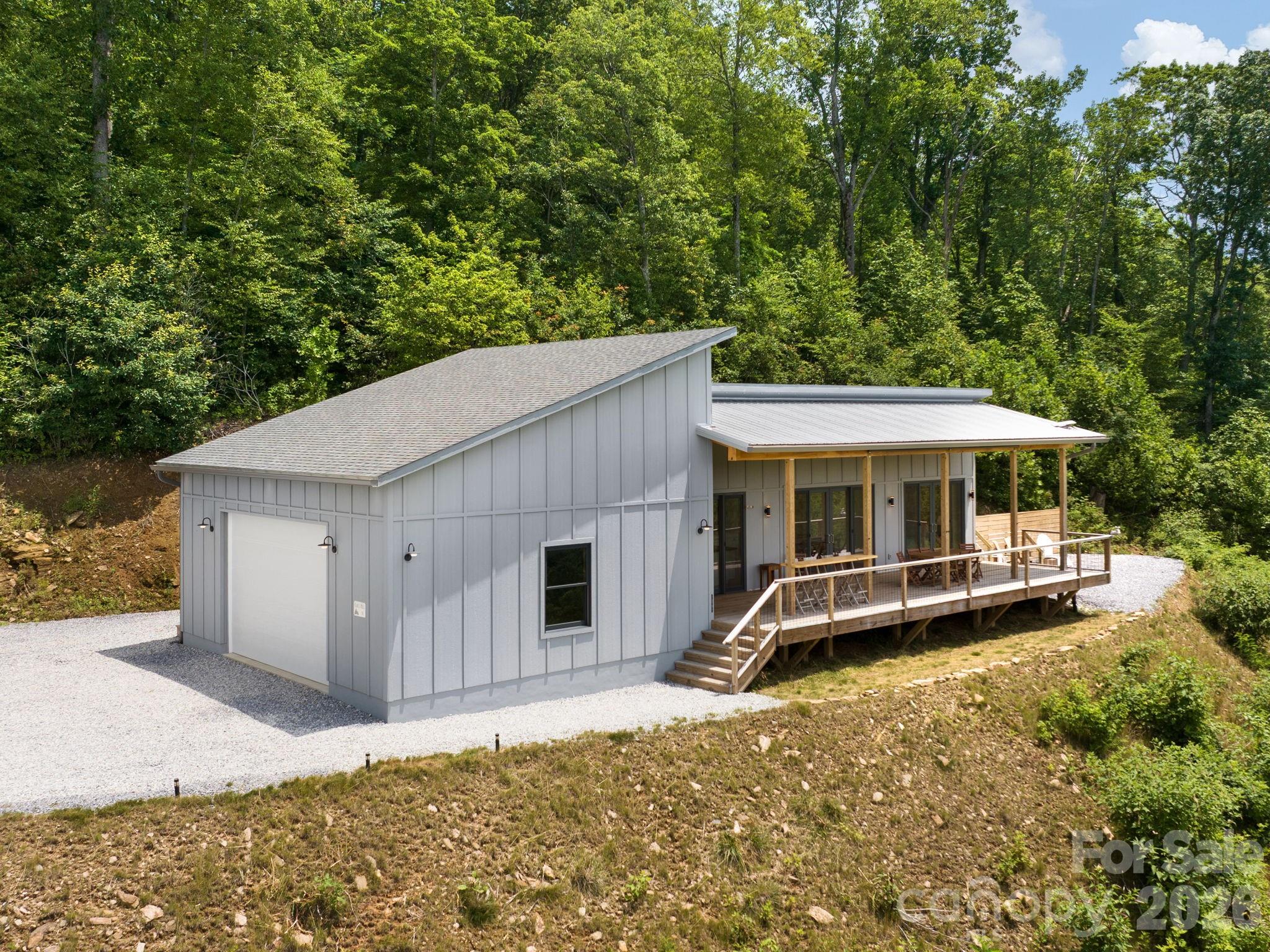 511 Emerald Mine Road Spruce Pine, NC 28777 - Photo 2 of 23 a backyard of a house with table and chairs