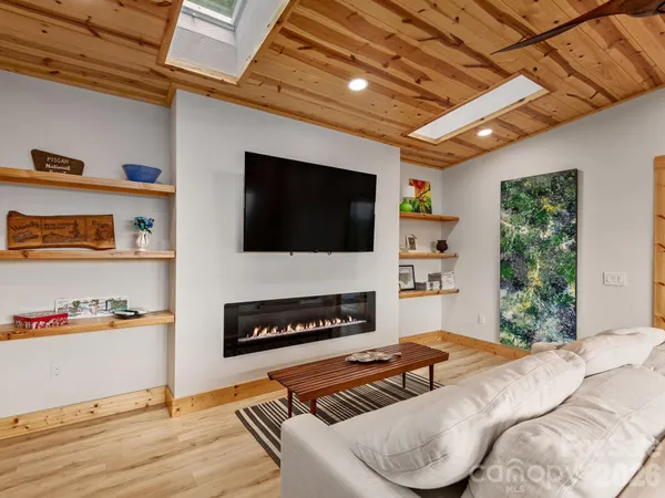 a bedroom with furniture and a flat screen tv