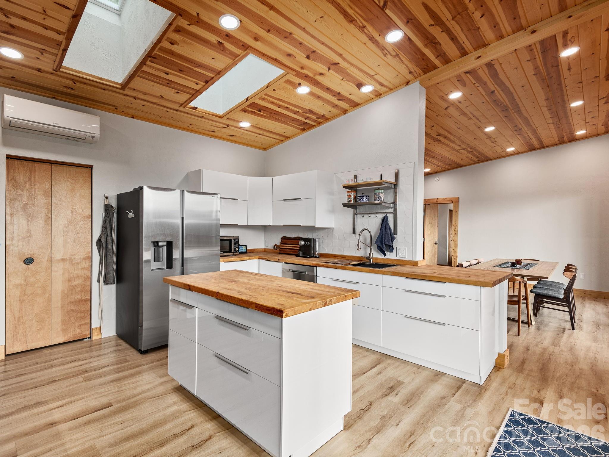 511 Emerald Mine Road Spruce Pine, NC 28777 - Photo 7 of 23 a kitchen with stainless steel appliances granite countertop a table chairs refrigerator and sink