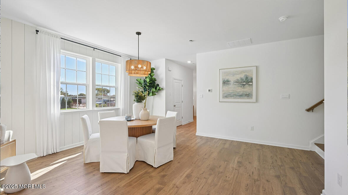 60 Penny Lane Neptune Township, NJ 07753 - Photo 13 of 37 a dining room with furniture a chandelier and wooden floor