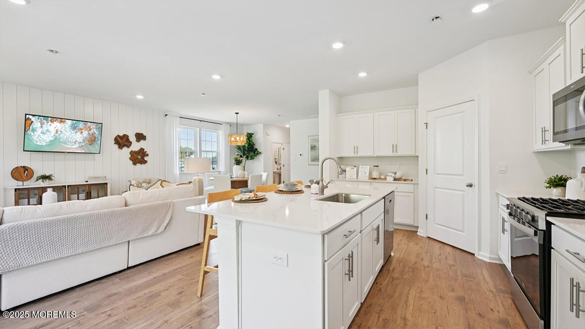 60 Penny Lane Neptune Township, NJ 07753 - Photo 18 of 37 a open kitchen with stainless steel appliances granite countertop a lot of counter space and wooden floors