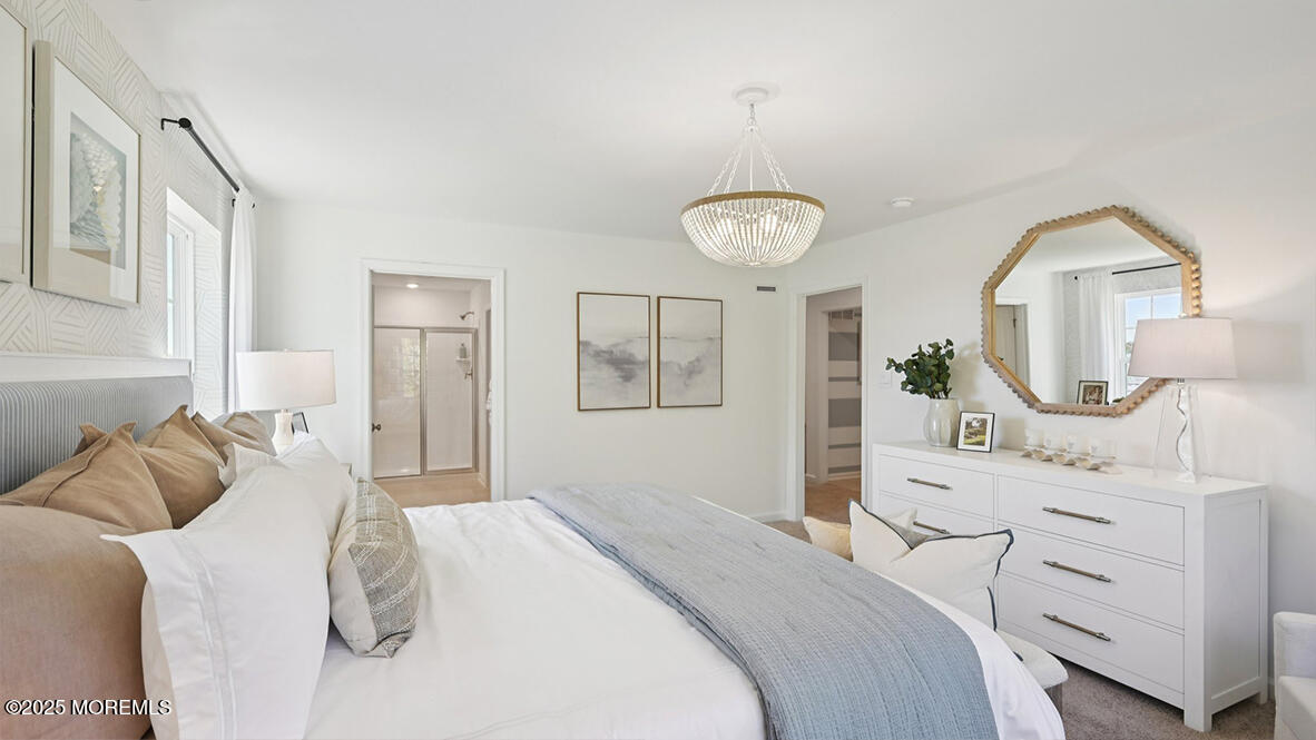60 Penny Lane Neptune Township, NJ 07753 - Photo 27 of 37 a bedroom with a bed a chandelier and mirror on the dresser