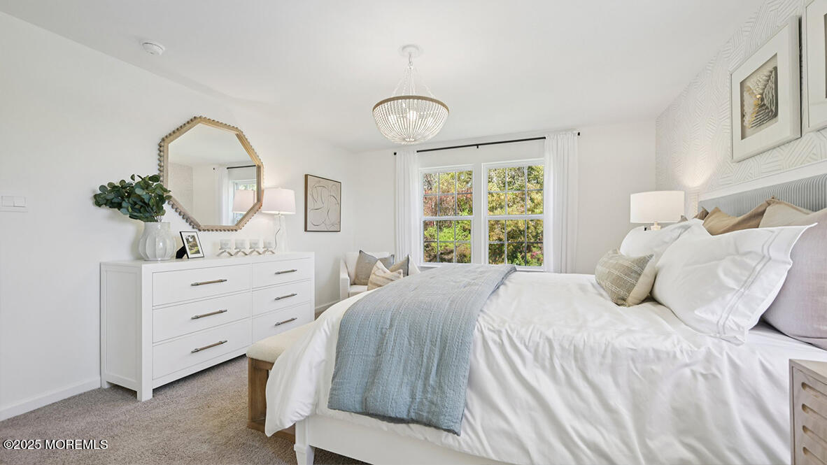 60 Penny Lane Neptune Township, NJ 07753 - Photo 28 of 37 a bedroom with a bed a mirror on dresser and a window