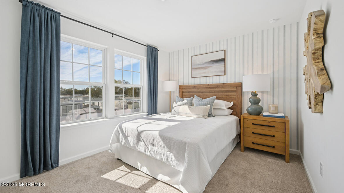 60 Penny Lane Neptune Township, NJ 07753 - Photo 34 of 37 a bedroom with a bed a mirror and a window