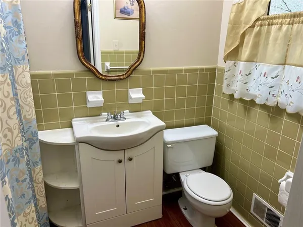 a bathroom with a sink mirror toilet and shower