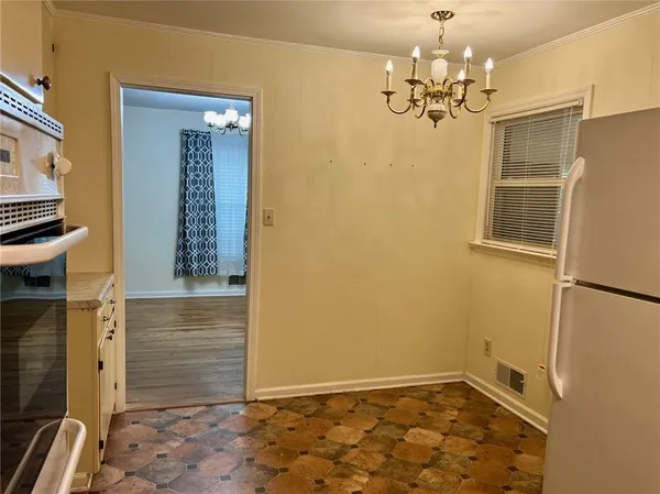 a view of a refrigerator in kitchen and wooden floor