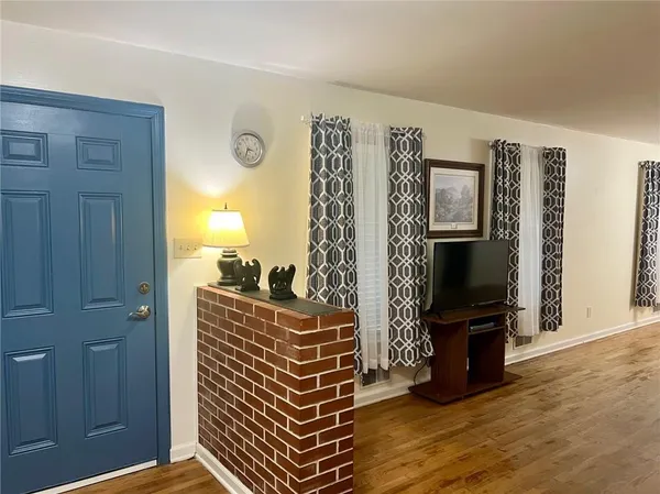 a view of room with furniture and wooden floor
