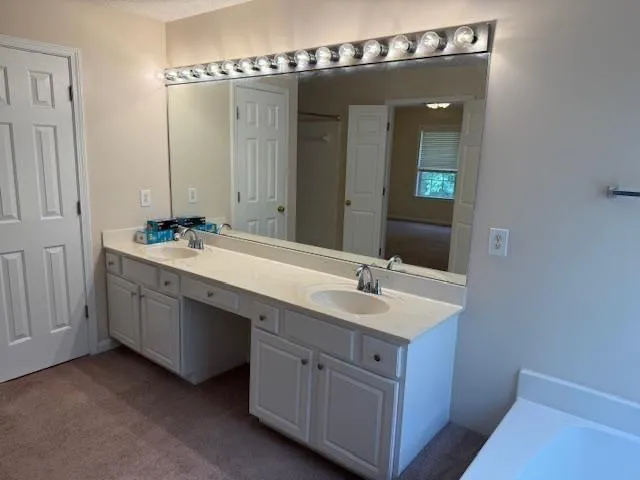 a bathroom with a double vanity sink and mirror