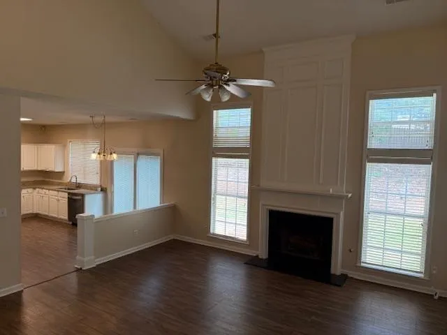 a kitchen with granite countertop a refrigerator and a stove top oven