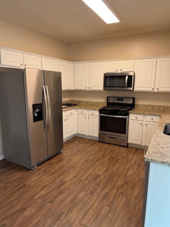 4168 Glenaire Way Northwest Acworth, GA 30101 - Photo 16 of 19 a kitchen with granite countertop a refrigerator and a stove top oven