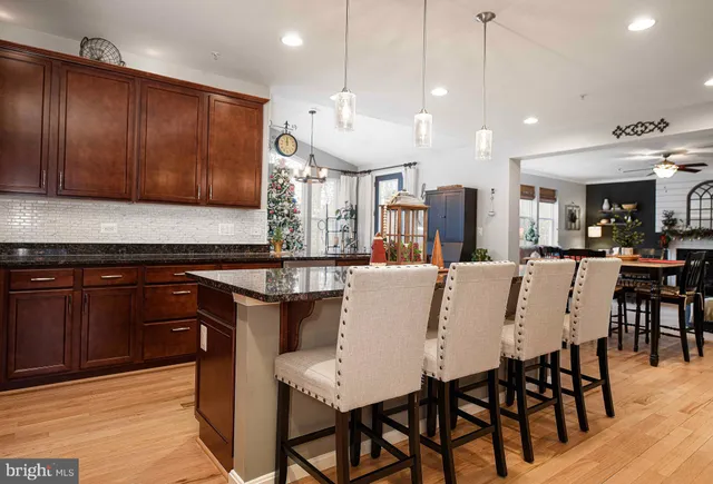 a large kitchen with a table and chairs