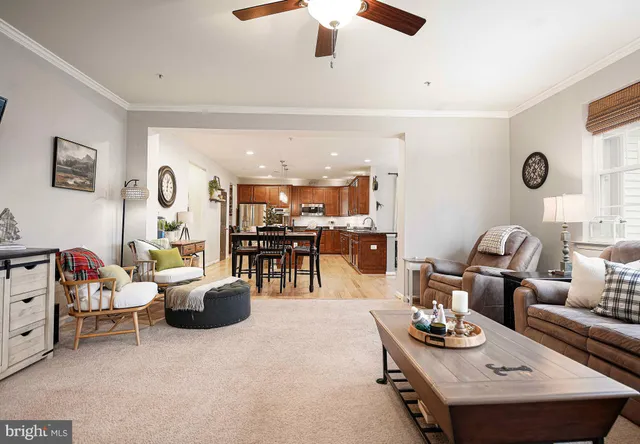 a living room with furniture and view of kitchen