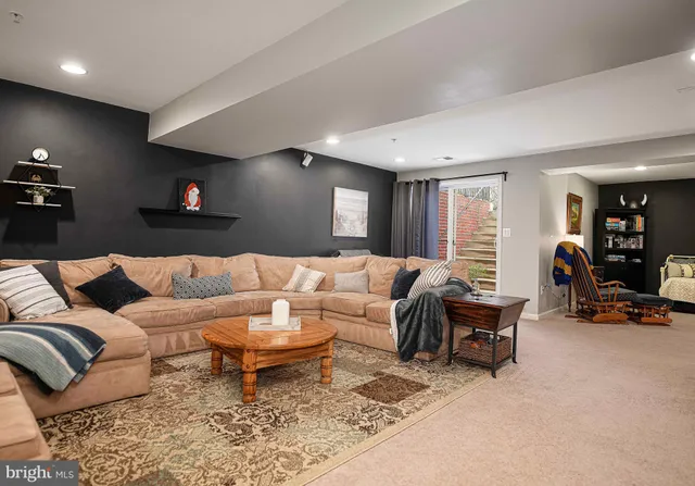 a living room with furniture a rug and a table