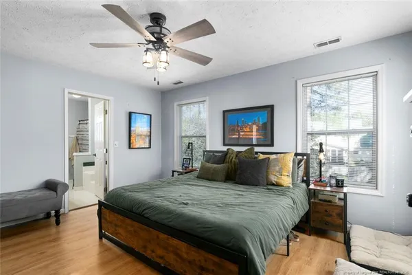 a bedroom with a large bed and a window