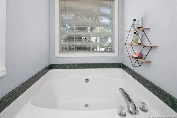 a bath tub sitting next to a window